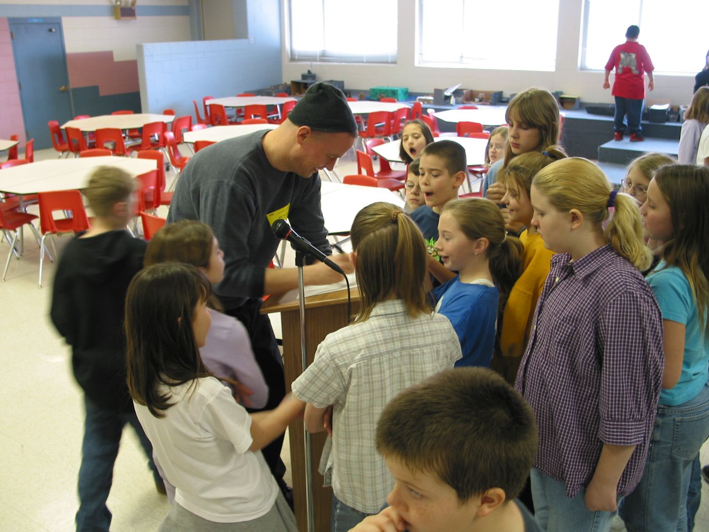 Lecture — Calvert Elementary School assembly, Lincoln, Nebraska, 2003: photograph 5 (Calvert students around Matt after the assembly)