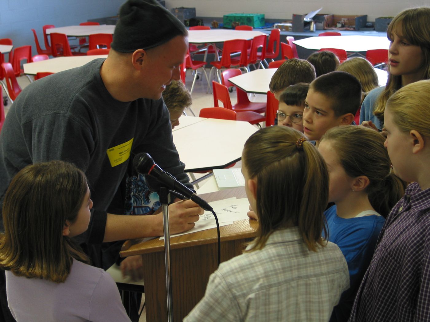 Lecture — Calvert Elementary School assembly, Lincoln, Nebraska, 2003: photograph 6 (Signing for the students at the podium)