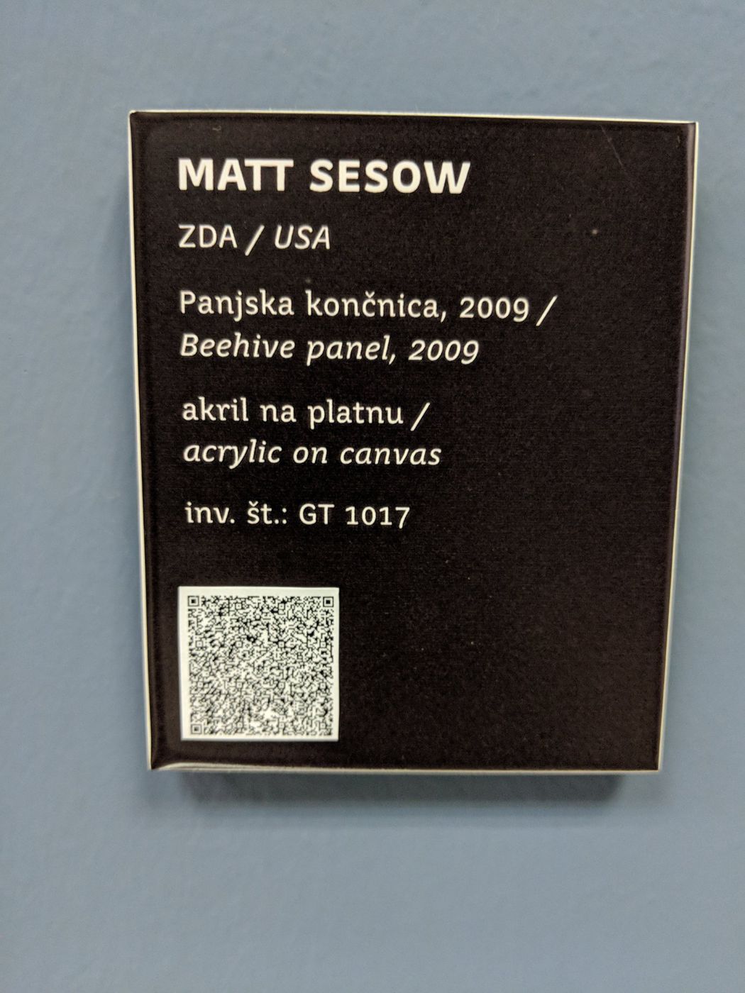“Beehive panel” enters the collection of the Gallery of Naive Artists, Trebnje, Slovenia (2009), 2009: photograph 2 (The museum label: “Matt Sesow, ZDA / USA, Panjska končnica, 2009 / Beehive panel, 2009, akril na platnu / acrylic on canvas, inv. št.: GT 1017” (photo June 2018))