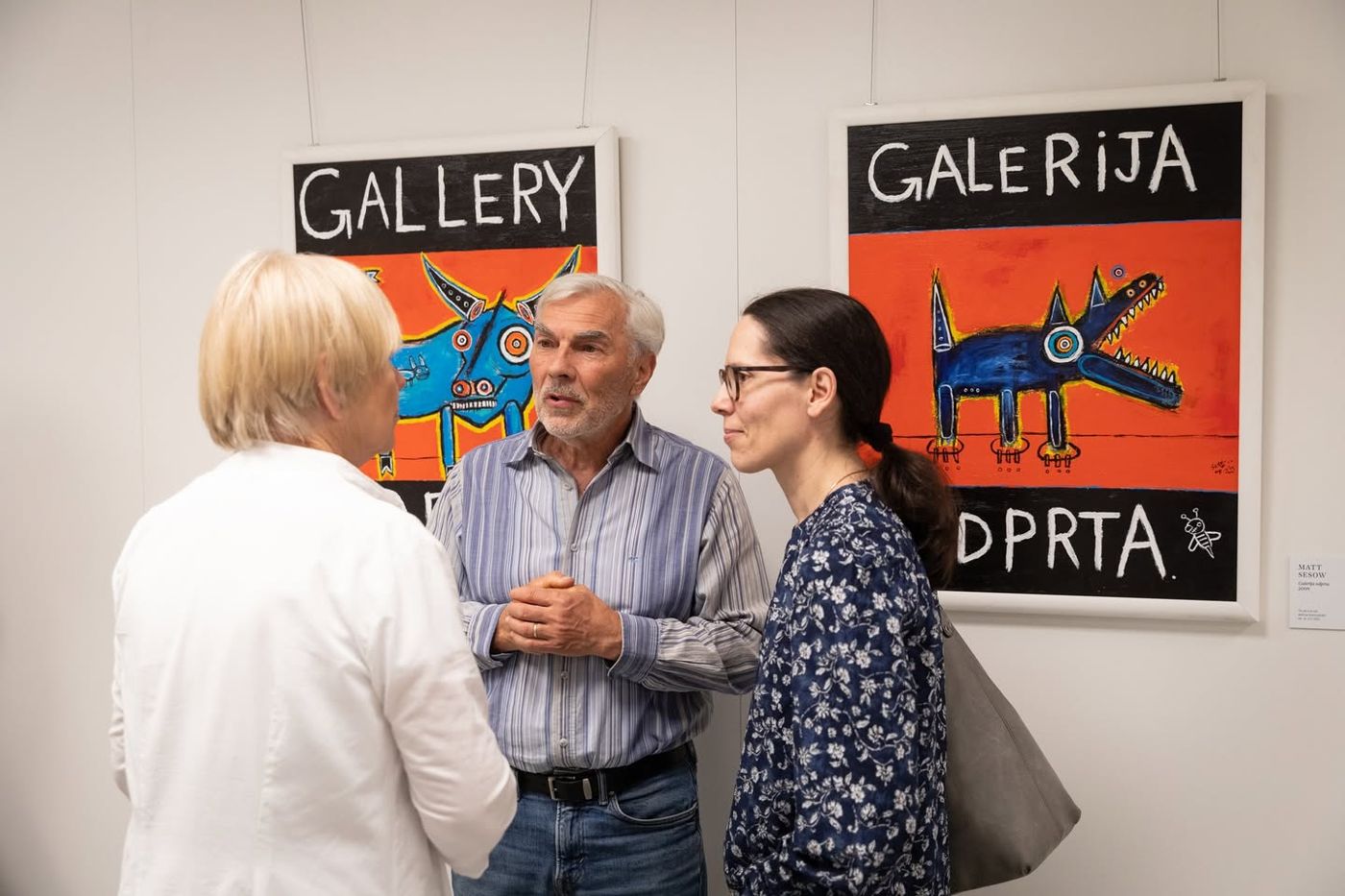 “Beehive panel” enters the collection of the Gallery of Naive Artists, Trebnje, Slovenia (2009), 2009: photograph 9 (Visitors in front of the two “Gallery Open” paintings, Trebnje, 2023)