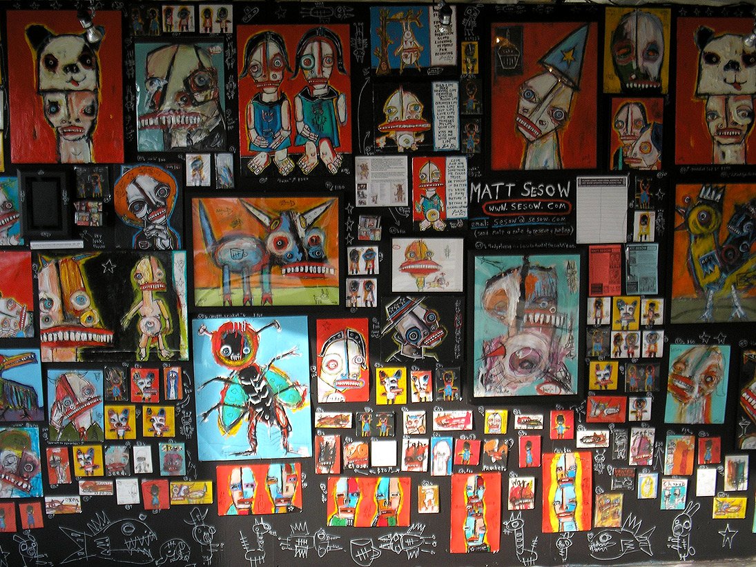 A wall of Sesow paintings at Artomatic, Washington DC
