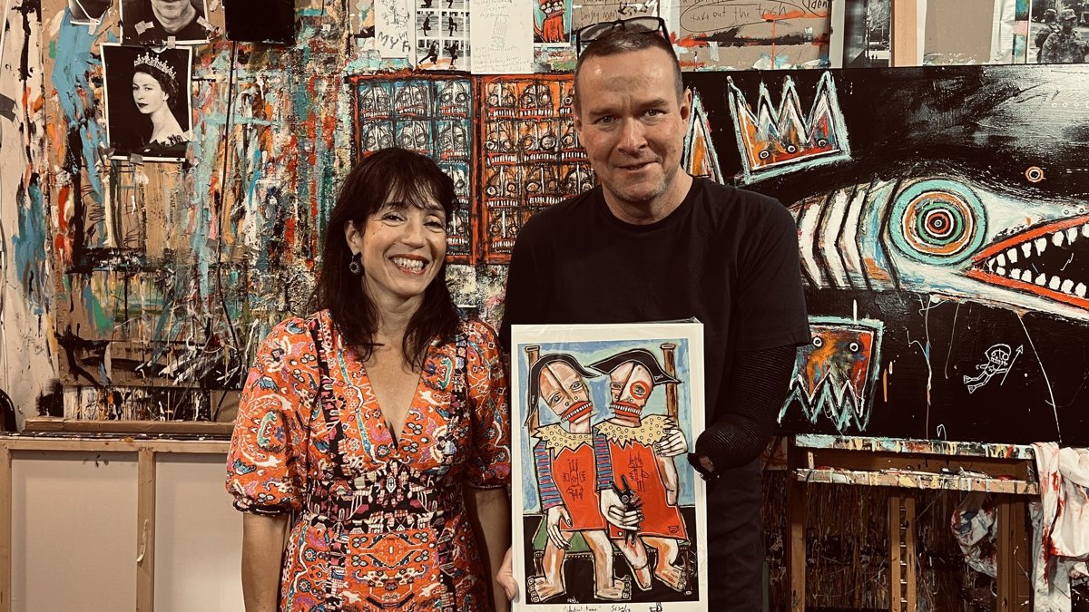 Suzanne de Vegh, executive director of the New Bedford Art Museum, with Matt Sesow and a print of his painting Identical Twins, October 10, 2026