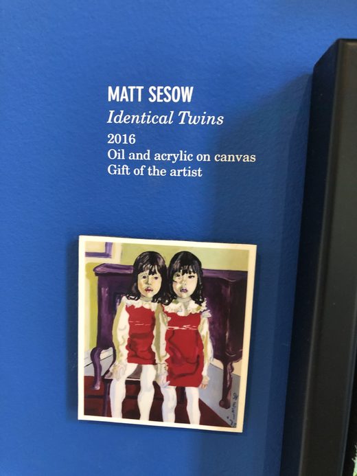 AVAM wall label for Matt Sesow, Identical Twins, 2016, gift of the artist, with a card of the Alice Neel painting